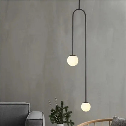Black metal pendant light with two spherical frosted glass globes in a gold minimalist iron chandelier decorbites black model