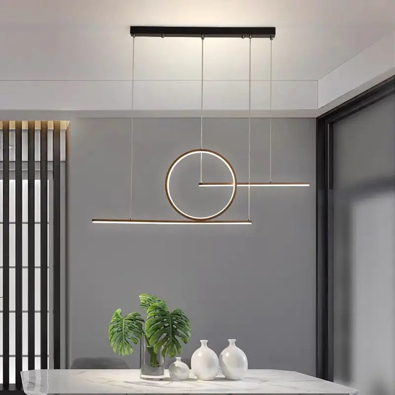 Modern minimalist LED dining room pendant light with black mount and warm white halo ring and horizontal bar glow