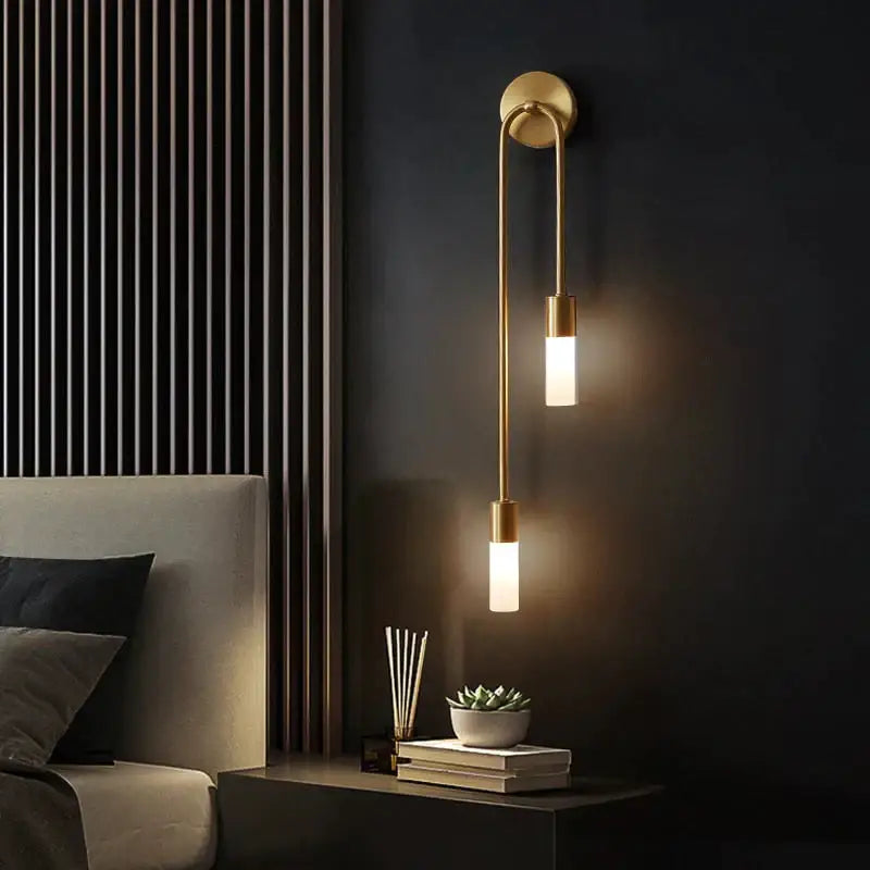 Modern gold minimalist led wall lamp with brass finish and two vertical frosted glass cylinders for bedroom use