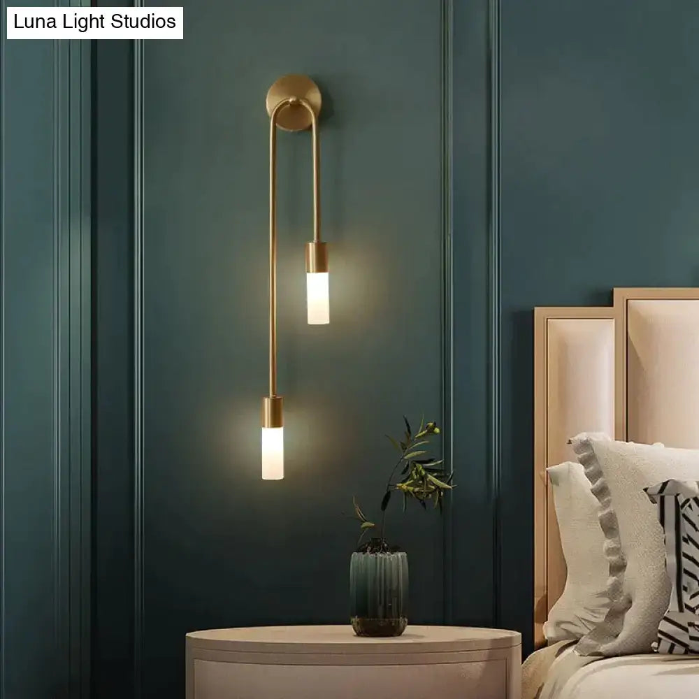 Modern gold minimalist led wall lamp with two vertical cylindrical frosted glass shades for bedroom lighting