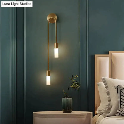 Modern gold minimalist led wall lamp with two vertical cylindrical frosted glass shades for bedroom lighting
