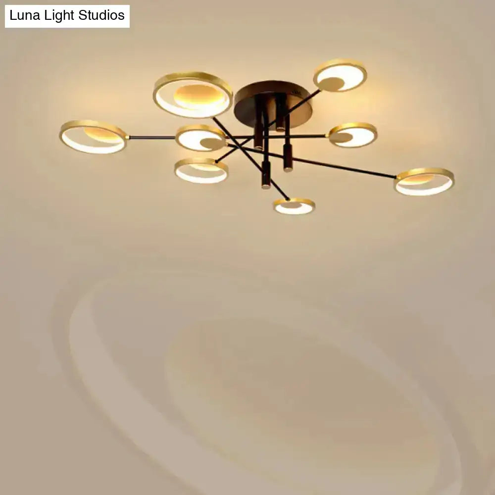 Modern gold molecule ceiling mount chandelier with eight gold-rimmed bulbs in starburst pattern on black metal arms