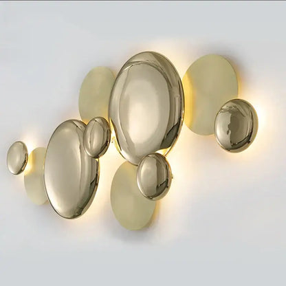 Modern gold nordic led wall lamp featuring a spherical cluster of glossy glass discs emitting warm ambient light