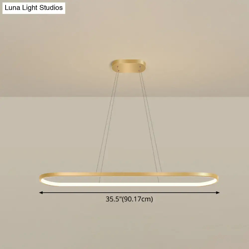 Modern gold oblong pendant light fixture with brushed gold finish and warm white led strip for dining room lighting