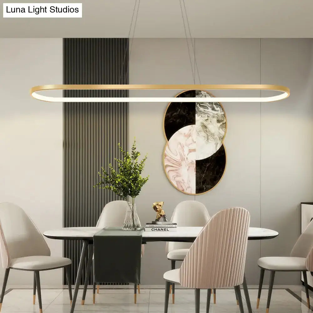 Modern gold-toned oval pendant light fixture with chain cord length and warm white color for dining room illumination