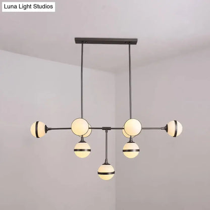 Modern black metal orb chandelier with six frosted glass globes and silver gold bulb base perfect for restaurants and hotels