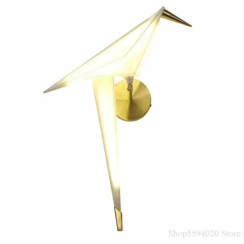 Modern gold origami bird led wall lamp with illuminated translucent wings and sleek metallic base for bedroom or living room