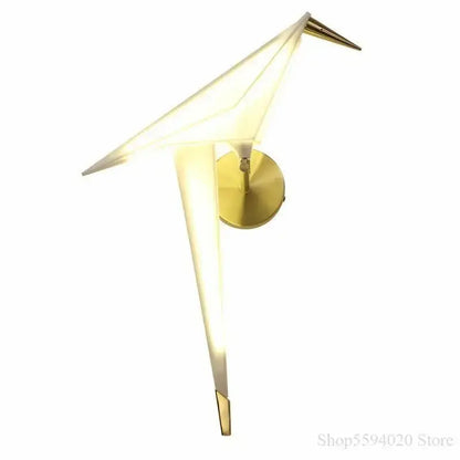 Modern gold origami bird led wall lamp with illuminated translucent wings and sleek metallic base for bedroom or living room