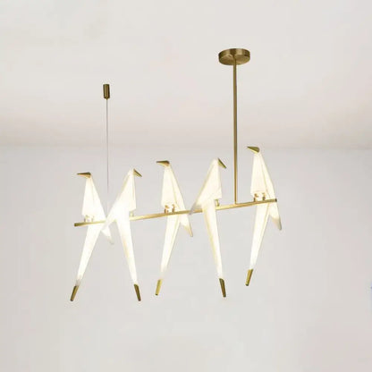 Modern gold origami bird pendant light featuring five illuminated translucent white birds with metallic beaks for dining room decor
