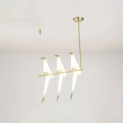 Modern gold origami bird pendant light with three illuminated triangular glass shades for dining room decor