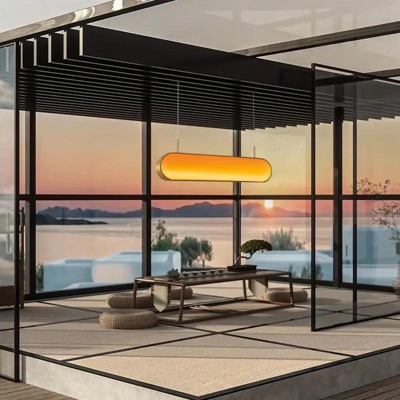 A sleek elongated orange decorbites led sunset chandelier with modern minimalist design for dining room lighting