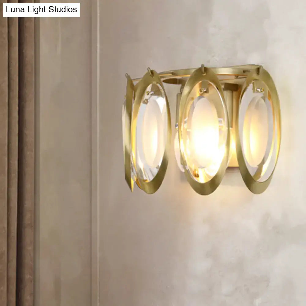 Modern gold oval sconce light with three translucent glass shades for elegant living room wall fixture