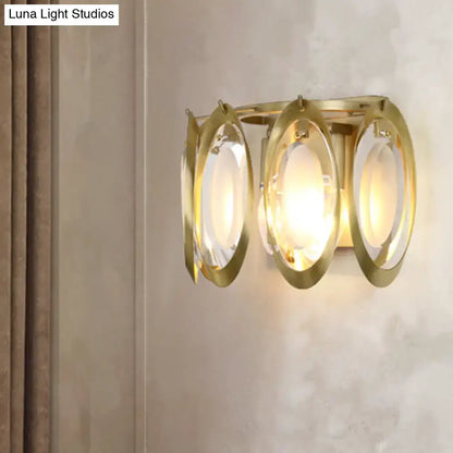 Modern gold oval sconce light with three translucent glass shades for elegant living room wall fixture