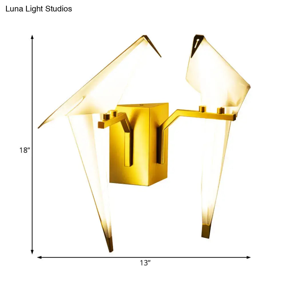 Modern gold wall lamp featuring a paper crane design with translucent white birdie plastic shade for dining room sconce