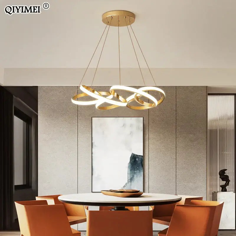 Modern gold plated led pendant lights featuring gold-toned interlocking circular rings for dining room decorbites lighting