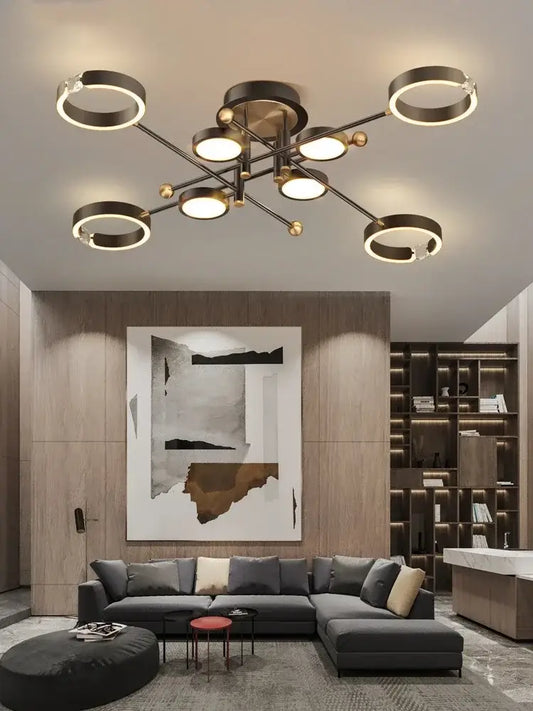 Modern gold plated luxury chandelier with multiple circular rings and spherical accents in brushed brass finish by decorbites