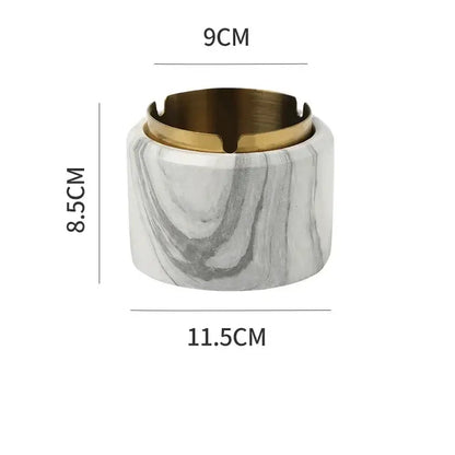 A sleek gold plated marble texture ashtray with a white gray exterior and polished gold interior rim by decorbites