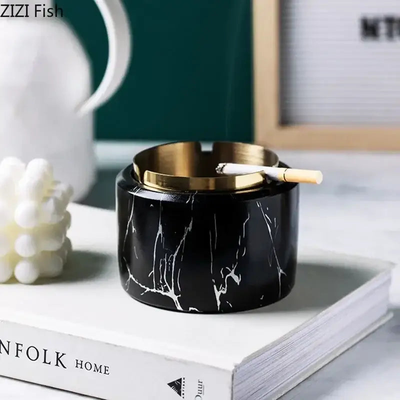 Black marble texture ashtray with gold plated rim and elegant white veining holding a single cigarette for living room decorbites gold plated