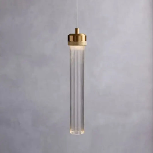 Modern gold pendant light with ribbed glass body and led bulbs providing warm illumination for dining room use