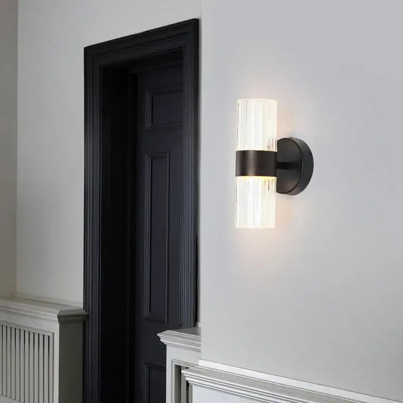 Modern black wall lamp with a textured translucent glass shade and sleek metal base for bedroom bedside use