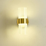 A modern gold wall lamp with clear ribbed glass shade luxury designed for bedroom bedside use