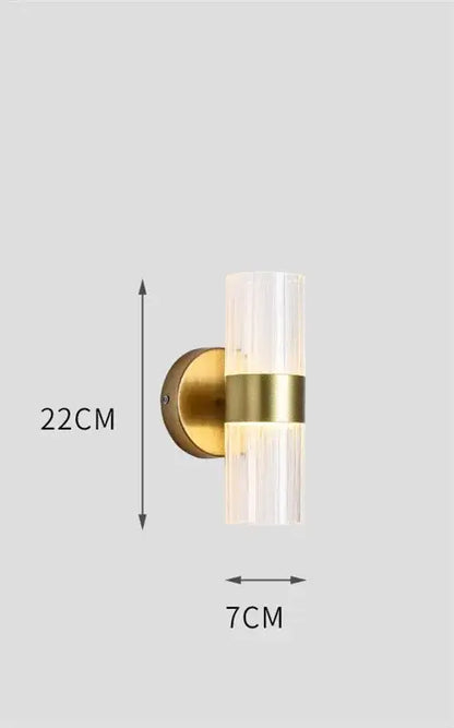 Modern gold wall lamp with ribbed glass shade and brass accent band designed for luxury bedroom bedside use