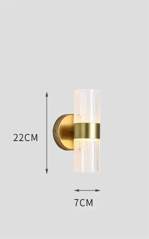Modern gold wall lamp with ribbed glass shade and brass accent band designed for luxury bedroom bedside use