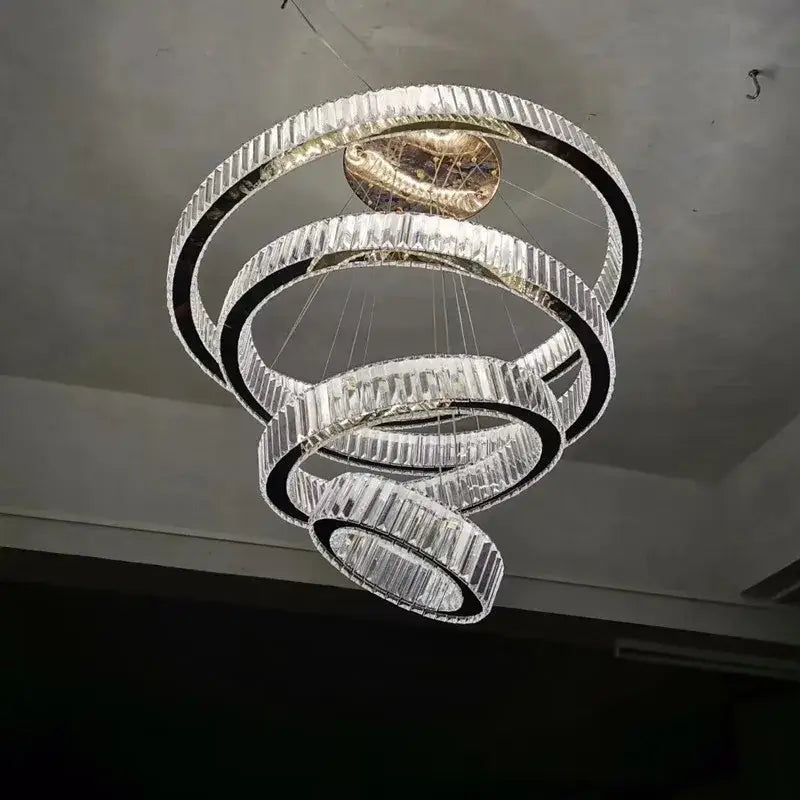 A modern gold ring decorbites crystal led chandelier with faceted crystal rings and central golden fixture for living room light