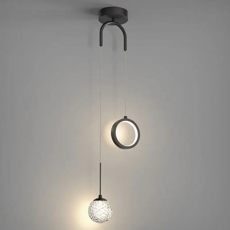 Modern black metal pendant light fixture with a circular ring and faceted glass globe for decorbites gold ring led lighting
