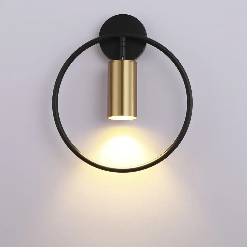 Modern black and gold circular wall sconce light with sleek minimalist design for adjustable bedroom lighting fixture