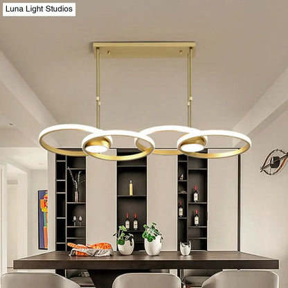 Modern gold ring pendant light with three interlocking circular rings and warm white integrated led bulbs for kitchen use
