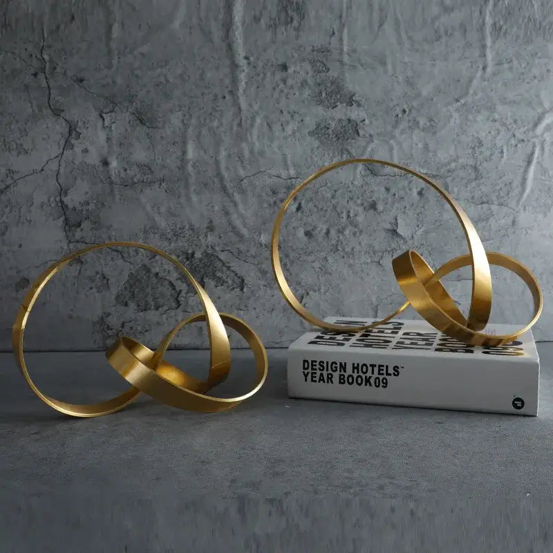 Modern gold rope knot metal sculpture with interlocking circular bands for home decor decorbites gold rope design