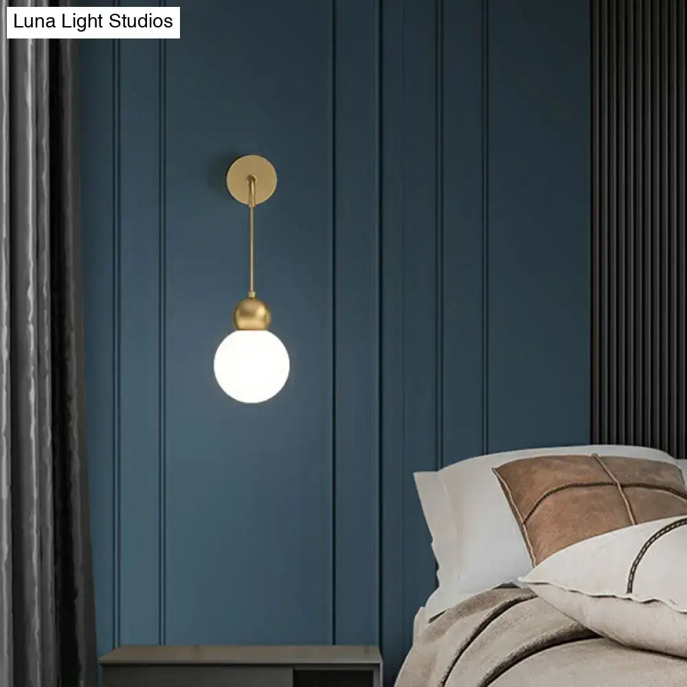 Modern gold sconce light wall lamp with milky glass spherical frosted bulb for bedroom use