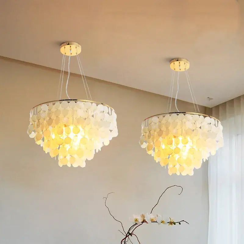 Two elegant modern gold shell chandelier lanterns with layered translucent white and pale yellow shell discs for living room decorbites gold shell