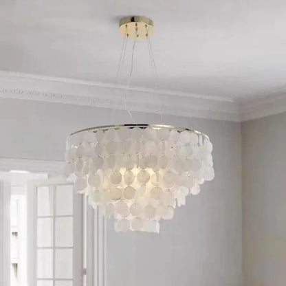 Modern gold shell chandelier with white multi-tiered circular shell discs and gold-toned ceiling mount for living room decorbites gold shell