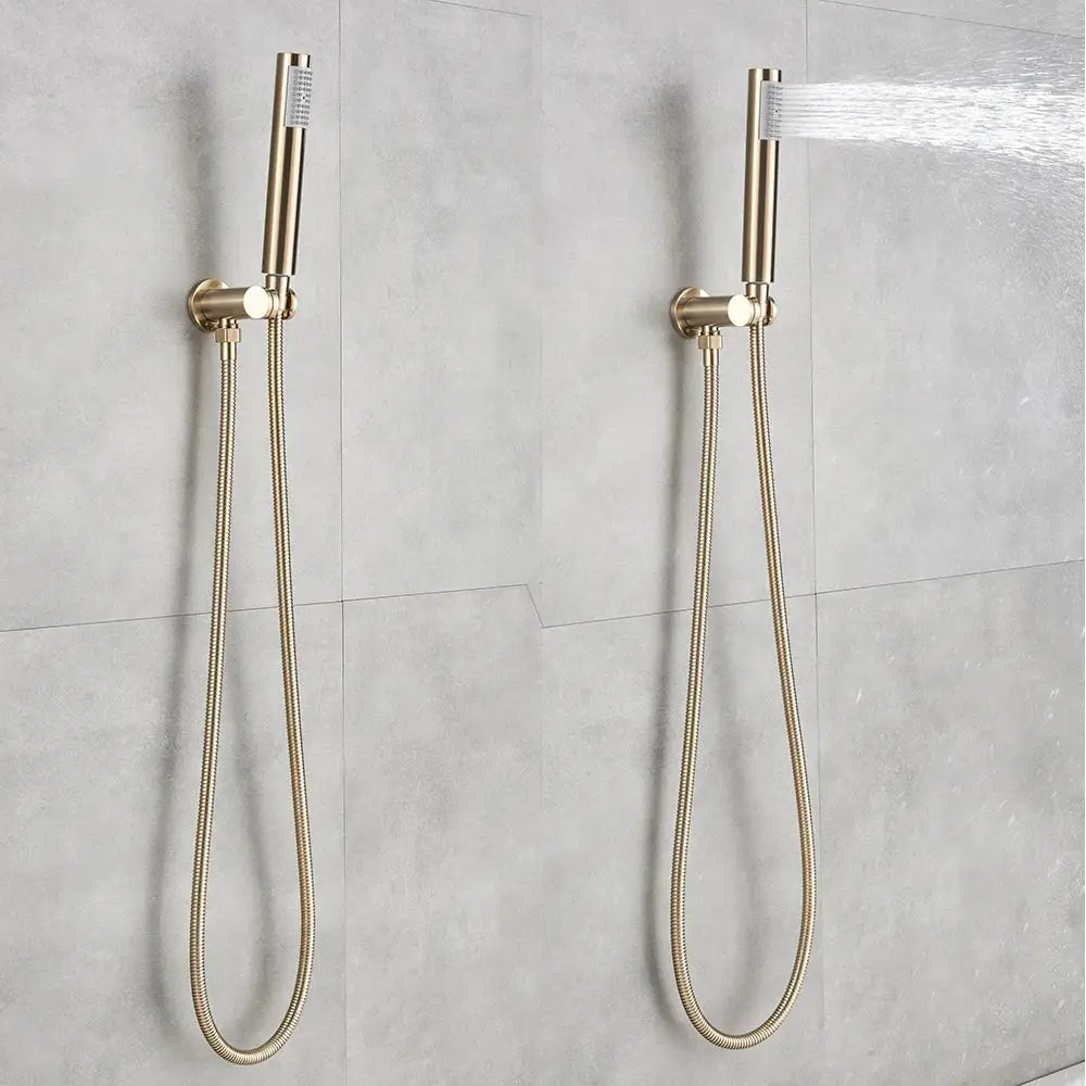 Two sleek gold shower faucet rainfall heads with flexible braided hoses mounted on a tiled wall by decorbites gold shower