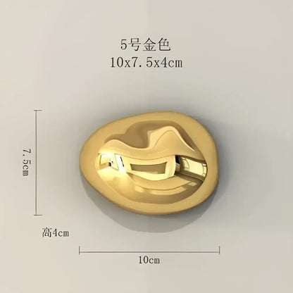 Modern gold 5-numbered metal button with a smooth oval shape and reflective surface for stone wall ornaments decor