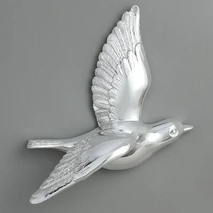 Silver metallic bird resin statue wall decor with detailed feather textures and polished reflective finish for children’s room