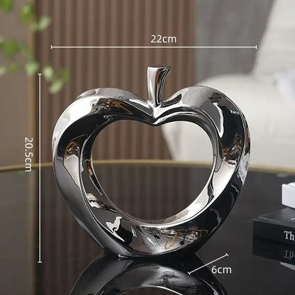 Shiny chrome heart-shaped apple sculpture in silver for modern golden apple sculpture living room decor