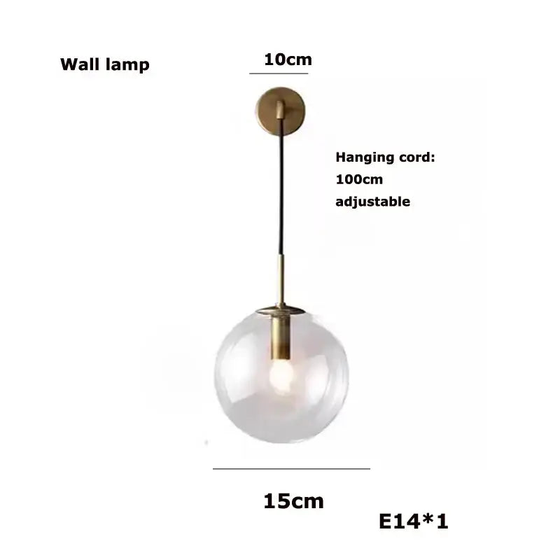 A modern gold and silver clear glass bubble chandelier featuring a clear glass globe with brass finish for dining room use