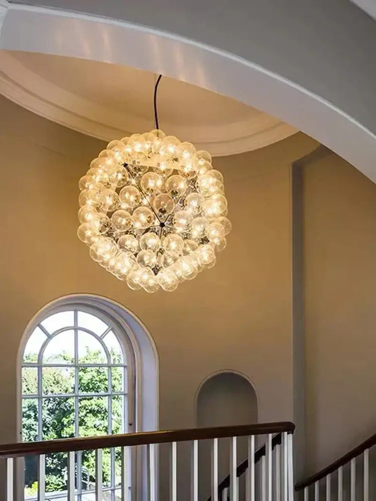 Modern gold and silver clear glass bubble chandelier with warm light composed of clear glass bulbs for dining room use