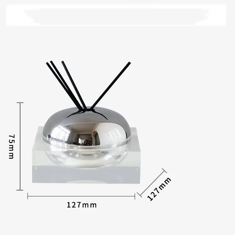 Silver dome-shaped aromatherapy diffuser with black reeds on clear acrylic base from decorbites golden geometry collection