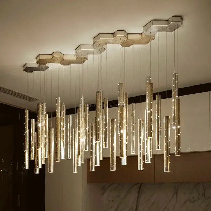 Modern pendant light featuring gold silver led cylindrical glass rods suspended from hexagonal metal fixtures for dining room decorbites gold silver chandelier