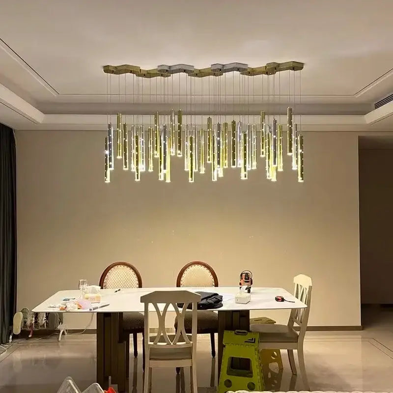 Modern gold and silver led pendant light chandelier with cascading cylindrical fixtures for dining room decorbites gold silver