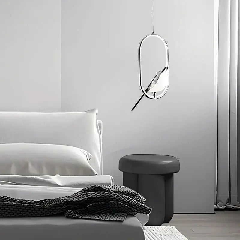 Modern gold and silver magpie led pendant light with metallic finish and bird silhouette for dining room lighting area