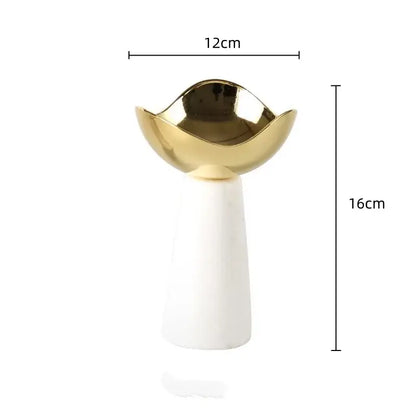 A modern dessert bowl with a glossy gold decorbites golden bowl top and smooth white marble base for dining