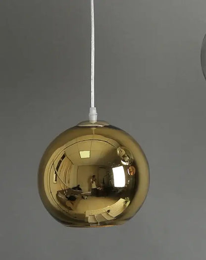 A sleek gold glass bubble ball pendant light with a polished reflective surface for modern kitchen decorbites pendant lights