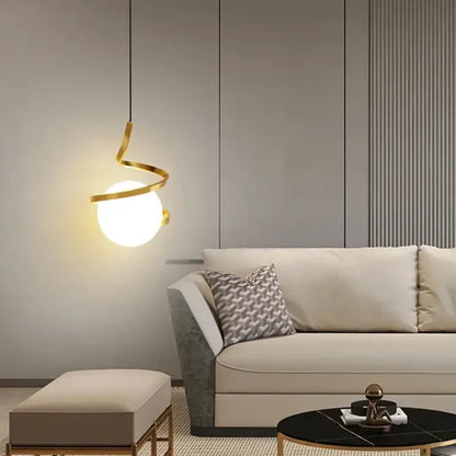 Modern gold spiral pendant light with glowing glass ball bulb and iron finish ideal for dining room lighting