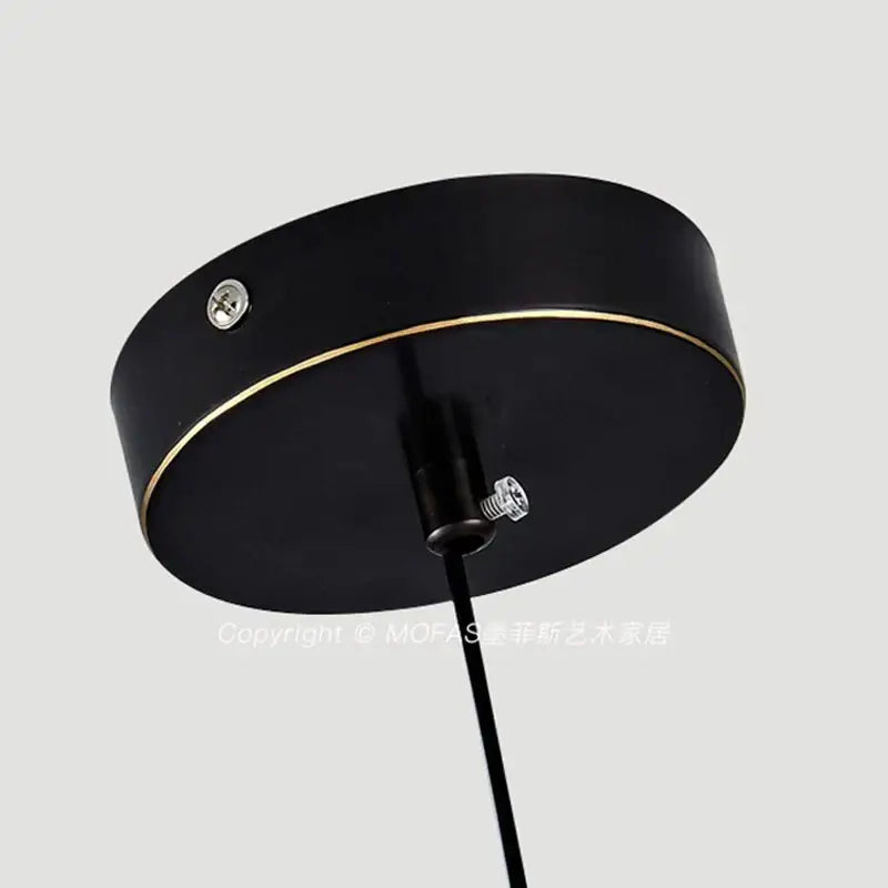 Black circular pendant light fixture with gold trim and aluminum alloy light source for modern dining room use