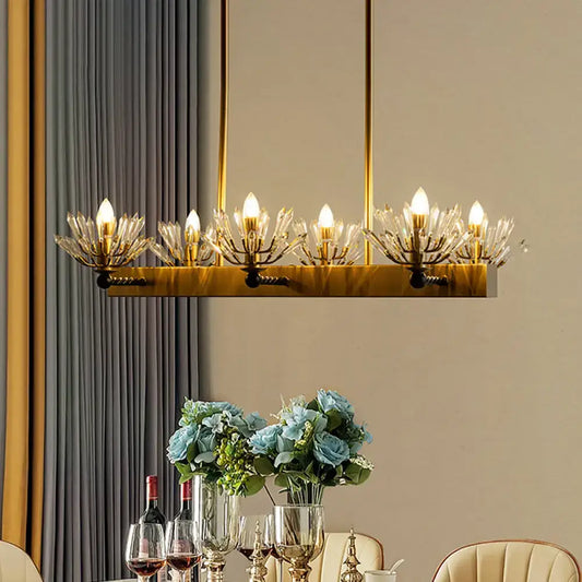 Gold-toned rectangular chandelier with crystal glass arms and illuminated bulbs for modern sputnik island light fixture